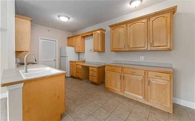 a kitchen with stainless steel appliances granite countertop a sink and cabinets with wooden floor