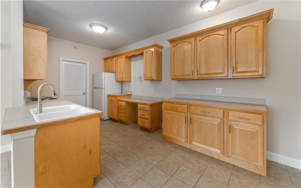 227 Adams Pointe Boulevard, Unit 3 Mars, PA 16046 - Photo 8 of 16 a kitchen with stainless steel appliances granite countertop a sink and cabinets with wooden floor