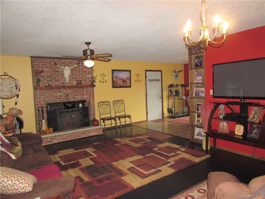2030 Orchard Road Smyrna, SC 29743 - Photo 22 of 24 a living room with furniture a flat screen tv and a fireplace