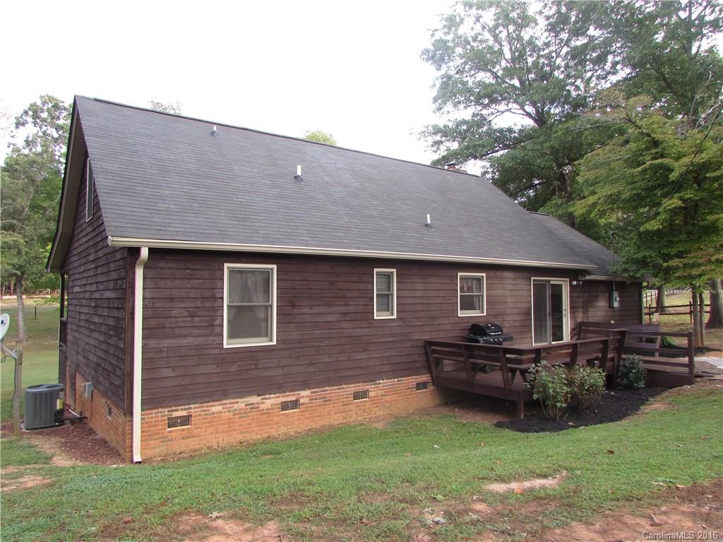 2030 Orchard Road Smyrna, SC 29743 - Photo 4 of 24 a backyard of a house with yard table and chairs