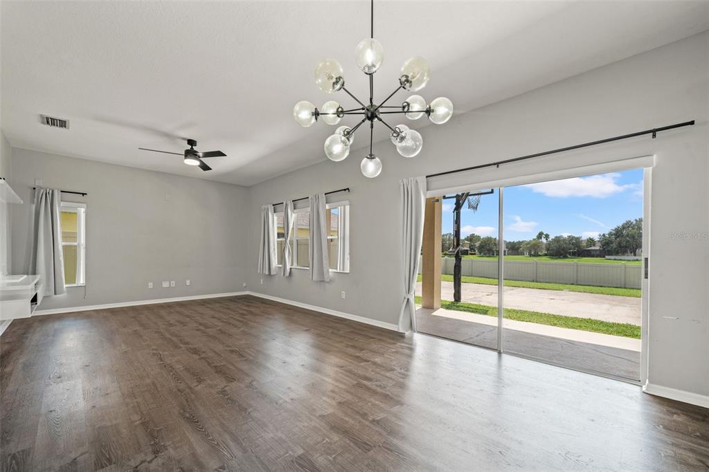 10909 Observatory Way Tampa, FL 33647 - Photo 16 of 39 an empty room with wooden floor and windows