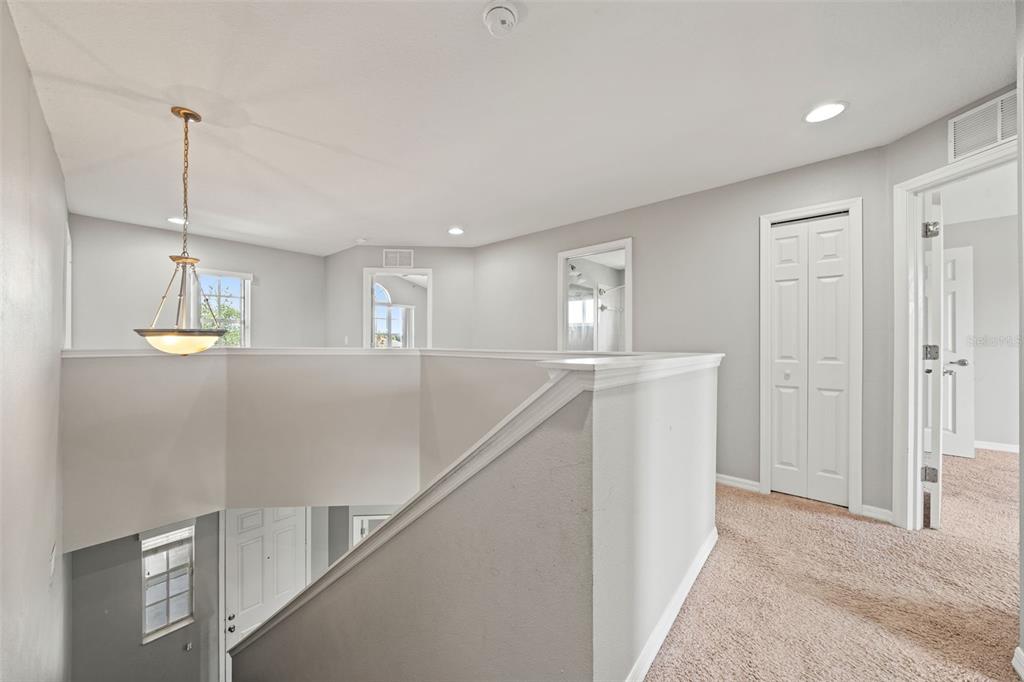10909 Observatory Way Tampa, FL 33647 - Photo 19 of 39 a view of an empty room with wooden floor and kitchen