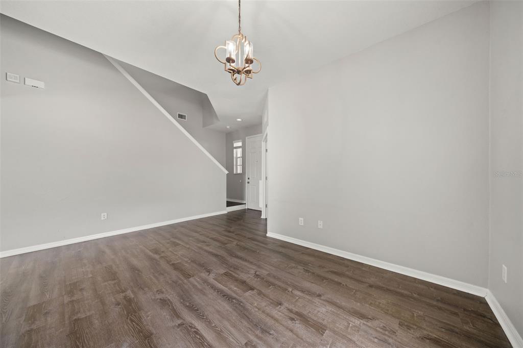 10909 Observatory Way Tampa, FL 33647 - Photo 6 of 39 a view of empty room with wooden floor and staircase