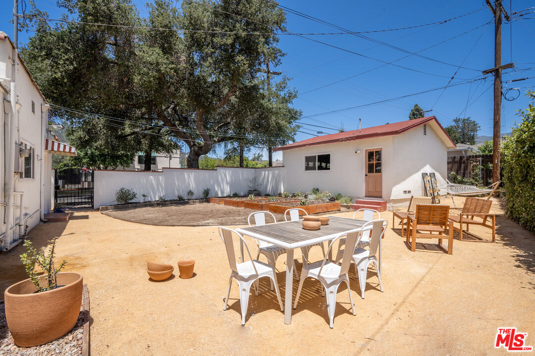 3201 Castera Avenue Glendale, CA 91208 - Photo 16 of 16 a view of a patio with table and chairs with wooden fence and plants