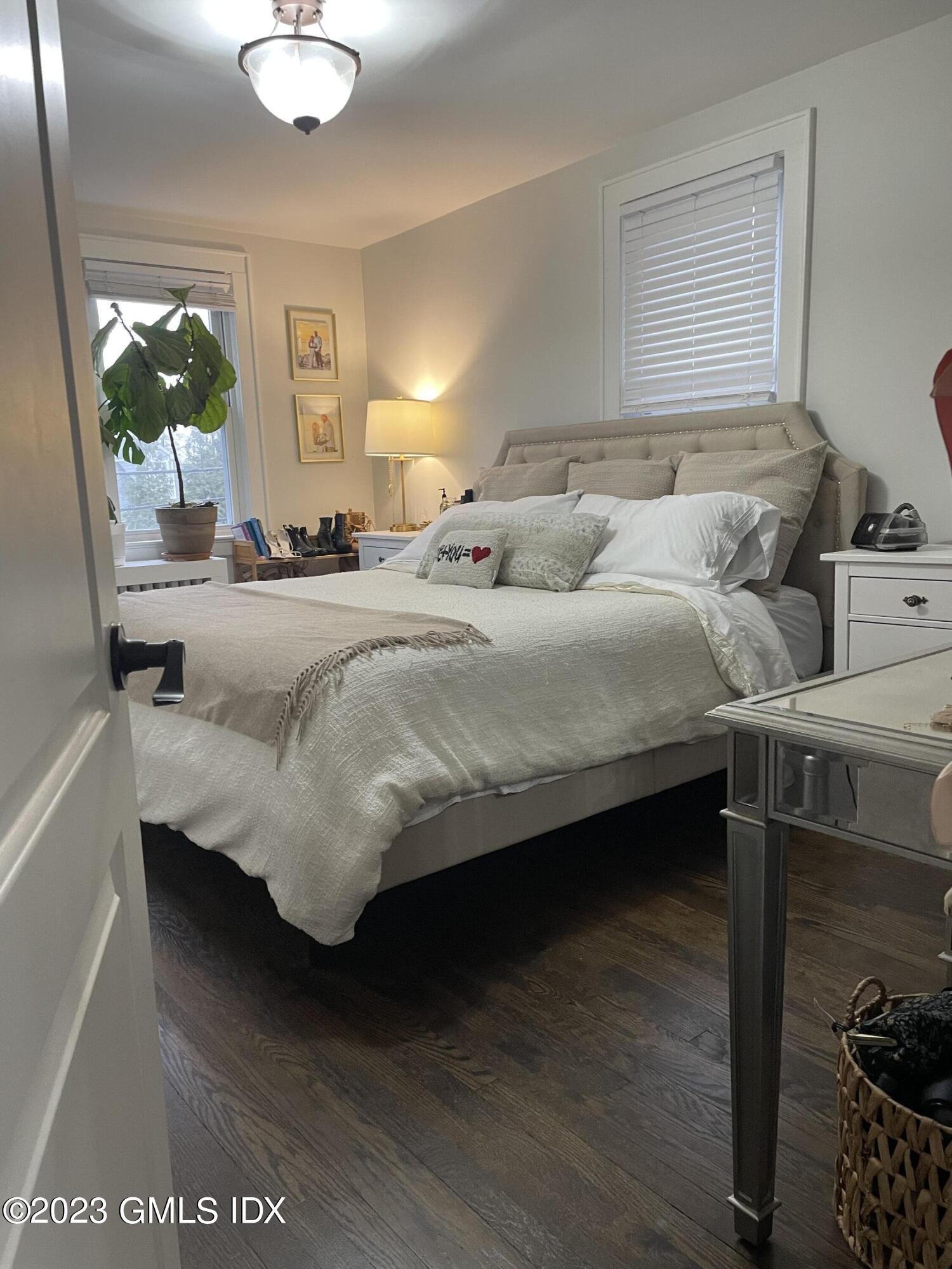 60 Weaver Street, Unit 2 Greenwich, CT 06831 - Photo 18 of 20 a bed sitting in a bedroom next to a window