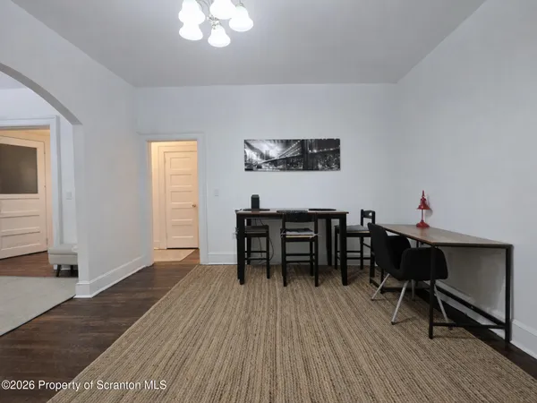 a view of a dining room with furniture and wooden floor