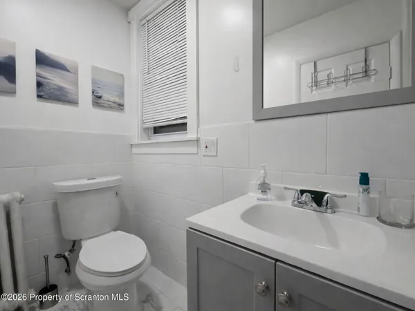 a bathroom with a sink toilet and a mirror