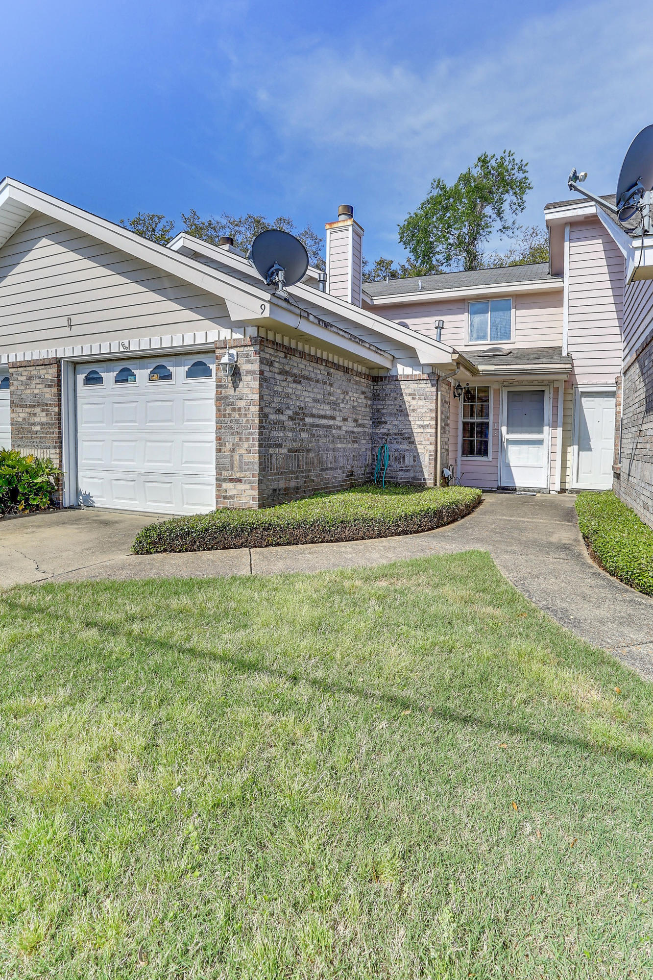 9 Falcon Ridge Lane, Unit 9 Fort Walton Beach, FL 32547 - Photo 1 of 23 a view of a house with a yard and plants