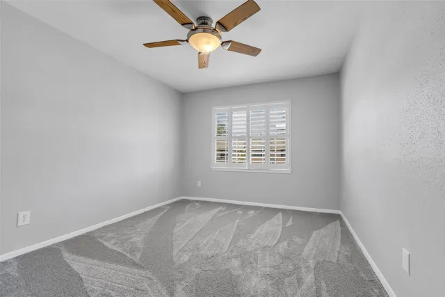 a bathroom with a granite countertop sink a toilet and a shower