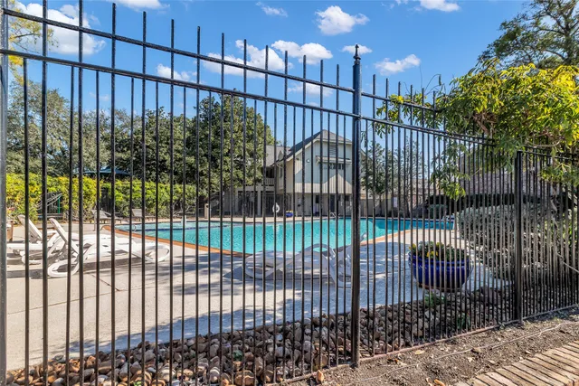 a view of a swimming pool with sitting area and furniture