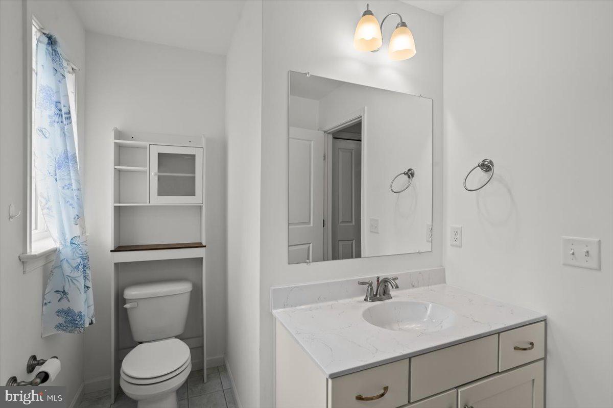 205 East Main Street Brownstown, PA 17508 - Photo 19 of 27 a bathroom with a toilet sink and mirror