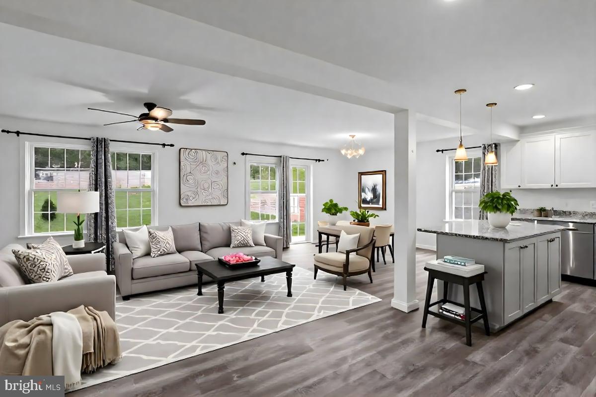 205 East Main Street Brownstown, PA 17508 - Photo 4 of 27 a living room with kitchen island furniture and a wooden floor