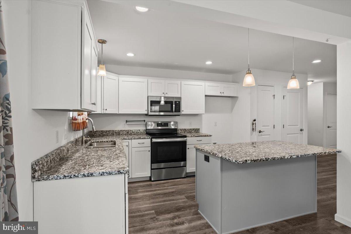 205 East Main Street Brownstown, PA 17508 - Photo 7 of 27 a kitchen with stainless steel appliances granite countertop a sink stove and cabinets