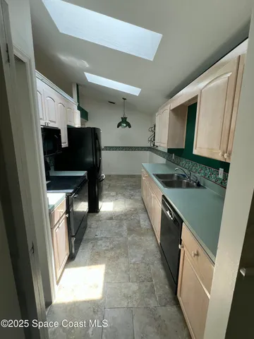 a kitchen with stainless steel appliances granite countertop a sink and a stove top oven