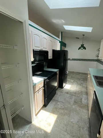 a kitchen with a sink and a stove top oven