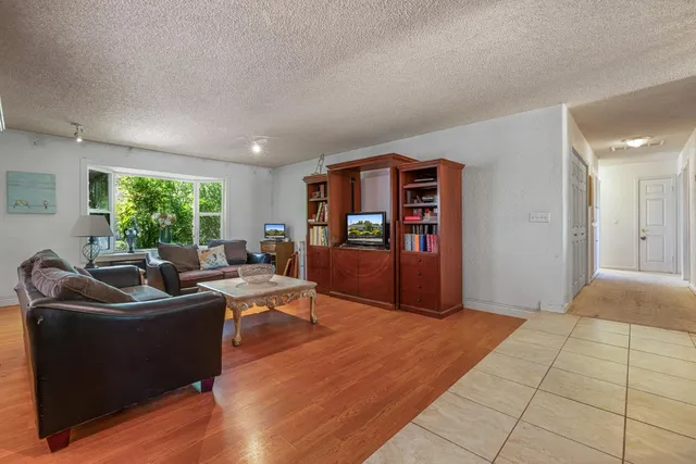 a kitchen with stainless steel appliances granite countertop a refrigerator and wooden cabinets