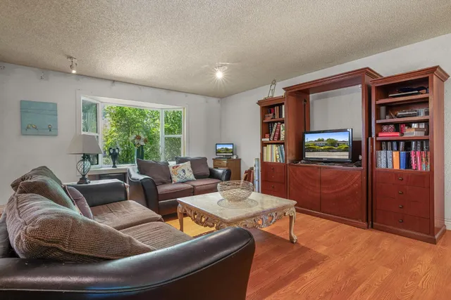 a kitchen with a sink and wooden floor