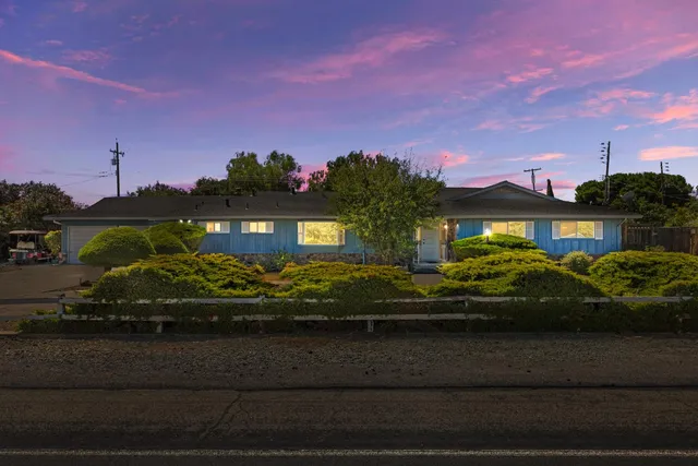 a front view of a house with a garden