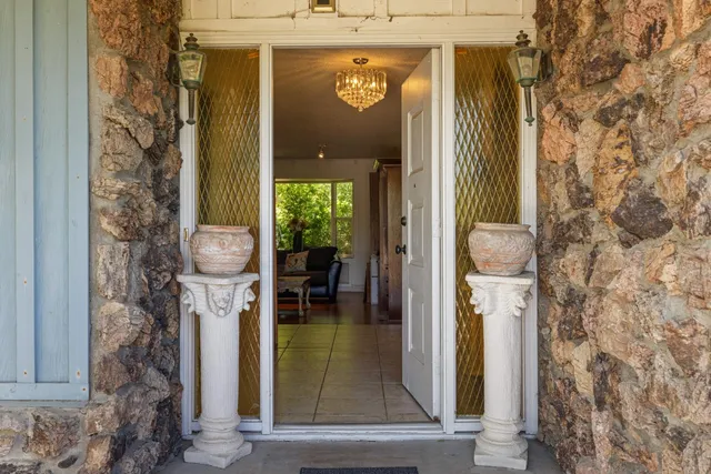 a living room with furniture a rug and a window