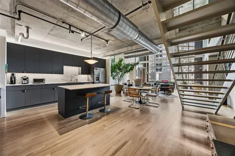 a kitchen with a sink dishwasher and a stove with wooden floors