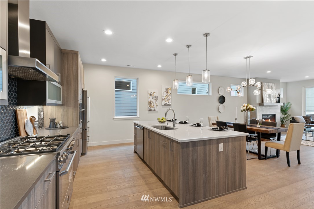 4558 22nd Avenue Southwest Seattle, WA 98106 - Photo 21 of 38 a kitchen with stainless steel appliances a sink stove and cabinets