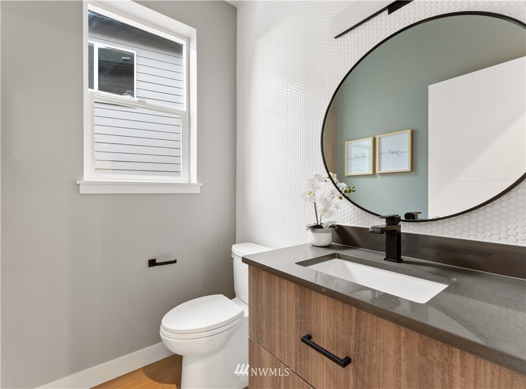 4558 22nd Avenue Southwest Seattle, WA 98106 - Photo 25 of 38 a bathroom with a toilet a sink and mirror