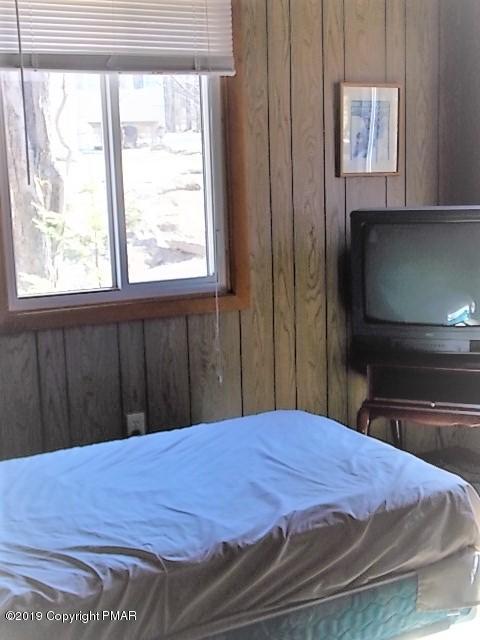 387 Ridge Road Pocono Lake, PA 18347 - Photo 12 of 14 a bed sitting in a bedroom with a balcony