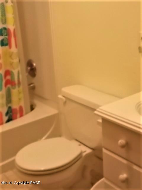 387 Ridge Road Pocono Lake, PA 18347 - Photo 14 of 14 a bathroom with a toilet and a bathtub