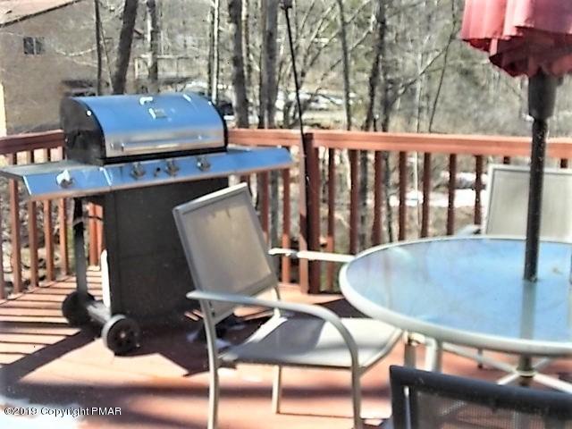 387 Ridge Road Pocono Lake, PA 18347 - Photo 2 of 14 a view of balcony with wooden floor and outdoor seating