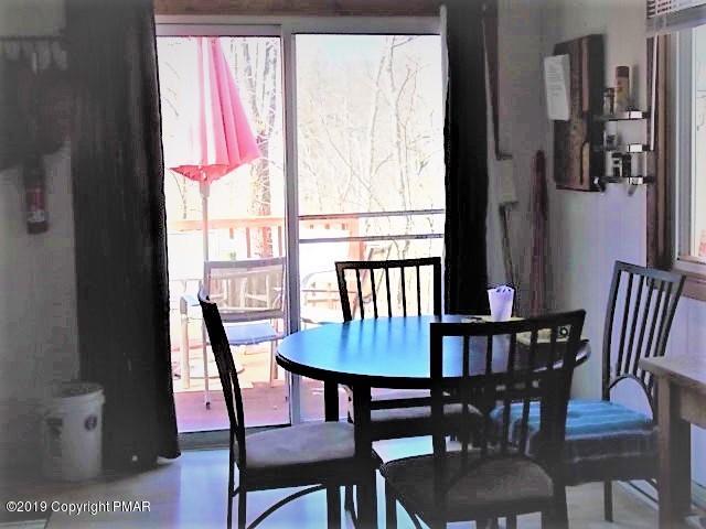 387 Ridge Road Pocono Lake, PA 18347 - Photo 7 of 14 a view of a dining room with furniture window and wooden floor