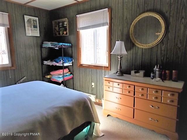 387 Ridge Road Pocono Lake, PA 18347 - Photo 10 of 14 a bed room with a bed and a dresser