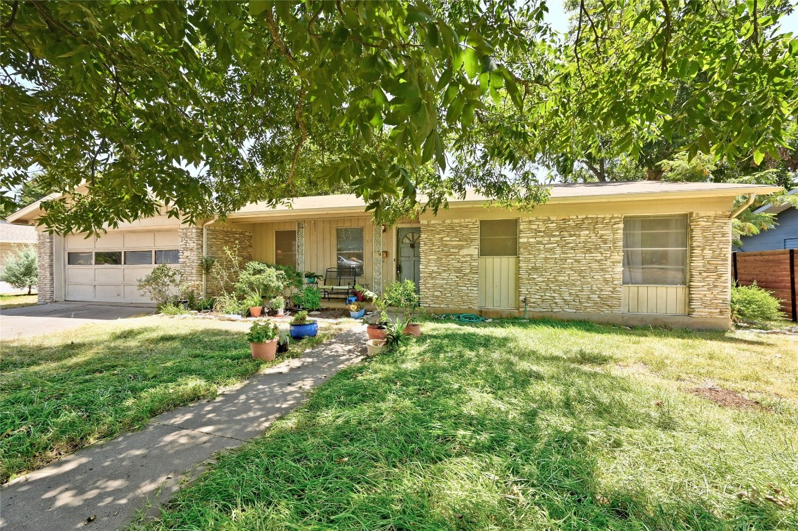 6613 Argentia Road Austin, TX 78757 - Photo 1 of 1 a backyard of a house with yard and outdoor seating