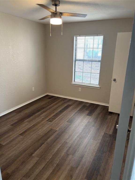 1733 Crest Grove Drive Arlington, TX 76012 - Photo 5 of 8 wooden floor in an empty room with a window