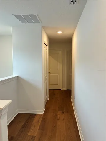 an empty room with wooden floor