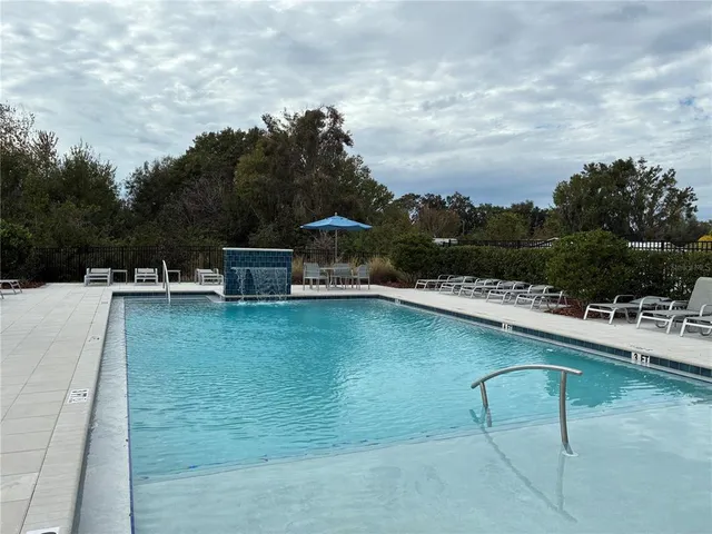 a view of a swimming pool with outdoor seating