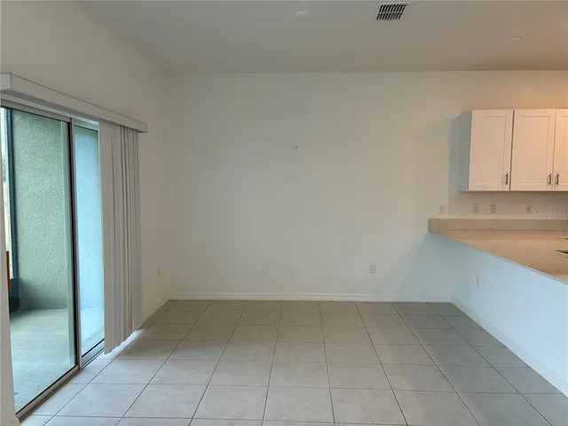 a view of a kitchen with white cabinets