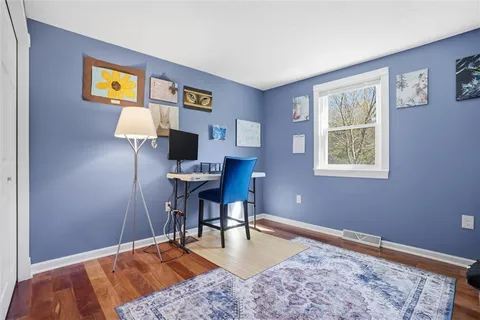 a workspace with furniture and wooden floor