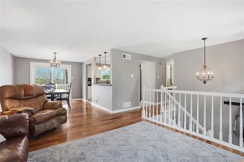 a kitchen with white cabinets and sink