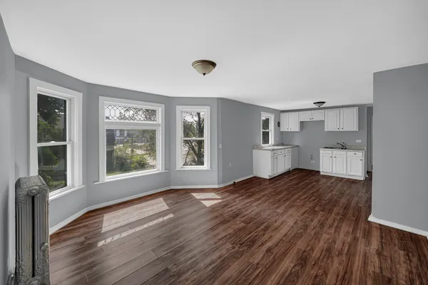 a view of a room with wooden floor and windows