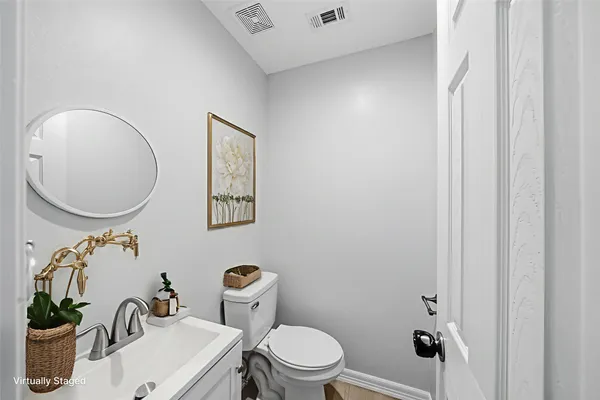 a bathroom with a toilet a sink and a mirror