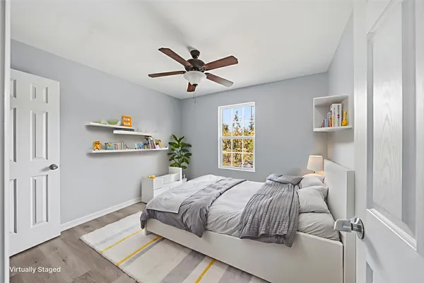 a bedroom with a bed and painting on the wall