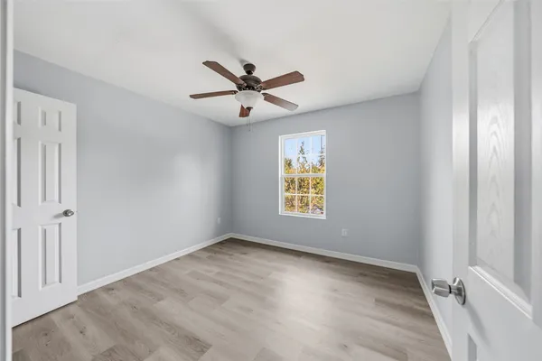 a view of an empty room and a window