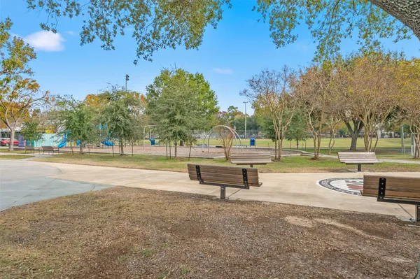 a park view with a bench and trees