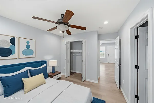 a bedroom with a bed and a ceiling fan