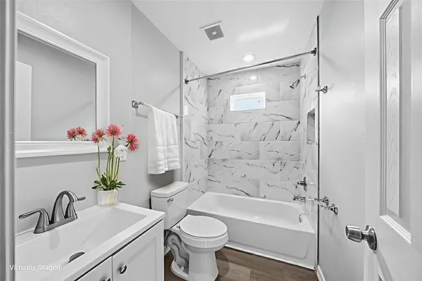 a bathroom with a sink toilet and shower