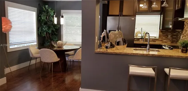 a kitchen with a refrigerator and cabinets