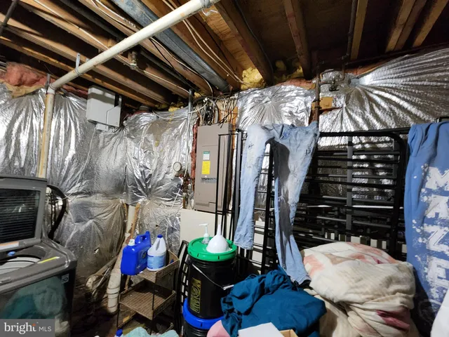 a room with lots of different colored cloths and a couch