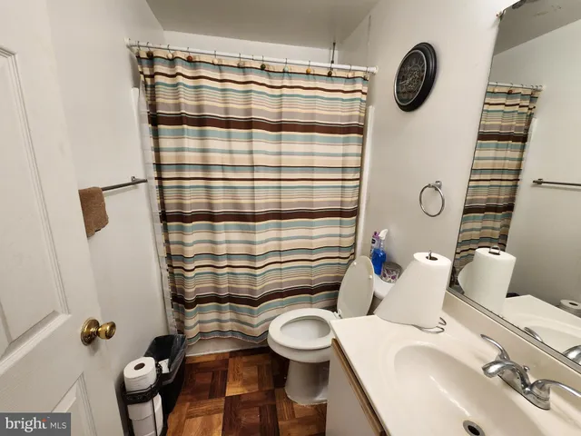 a bed sitting in a bedroom next to a lamp