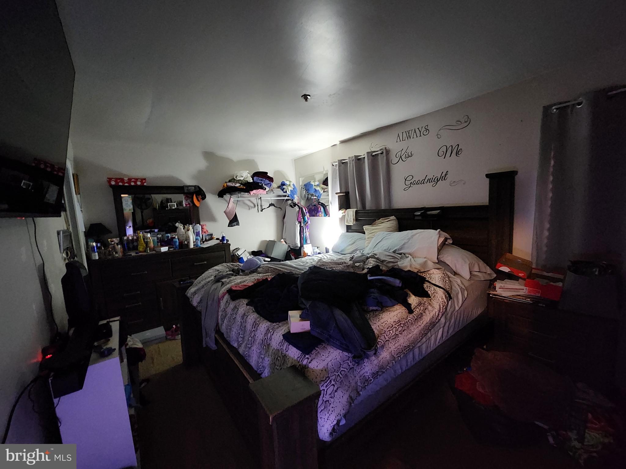 3901 Princely Way Baltimore, MD 21208 - Photo 19 of 23 a bed sitting in a bedroom next to a lamp