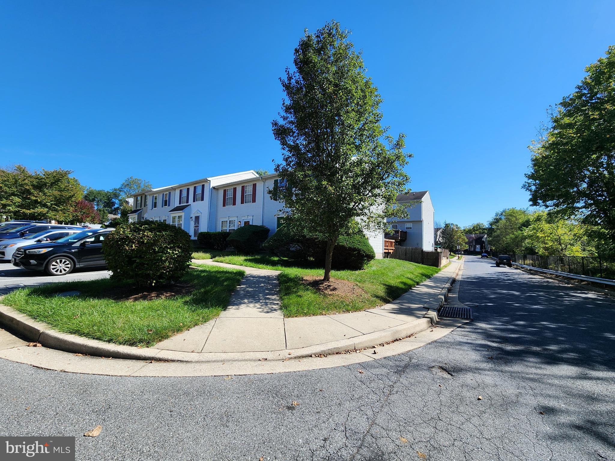 3901 Princely Way Baltimore, MD 21208 - Photo 22 of 23 a view of a white house with a yard plants and palm trees